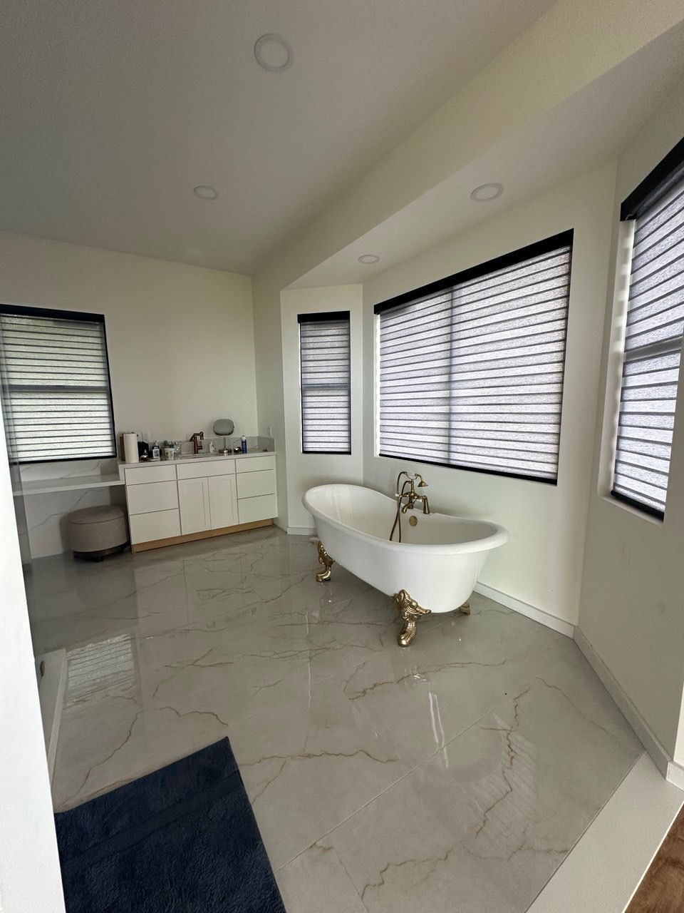 Banded shades in a marble bathroom